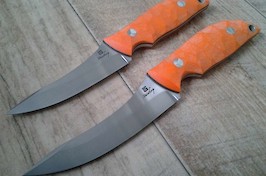 A pair of Capreolus knives, one standard and an XL...both in Sandvik 14C28N and blaze orange G10