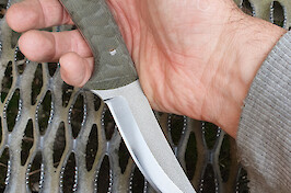 Flat ground in the incredibly tough A-8 modified steel with green canvas micarta scales.
