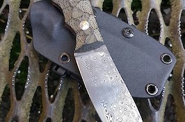Gorgeous Rose pattern Damasteel skinner with black micarta and red liners.